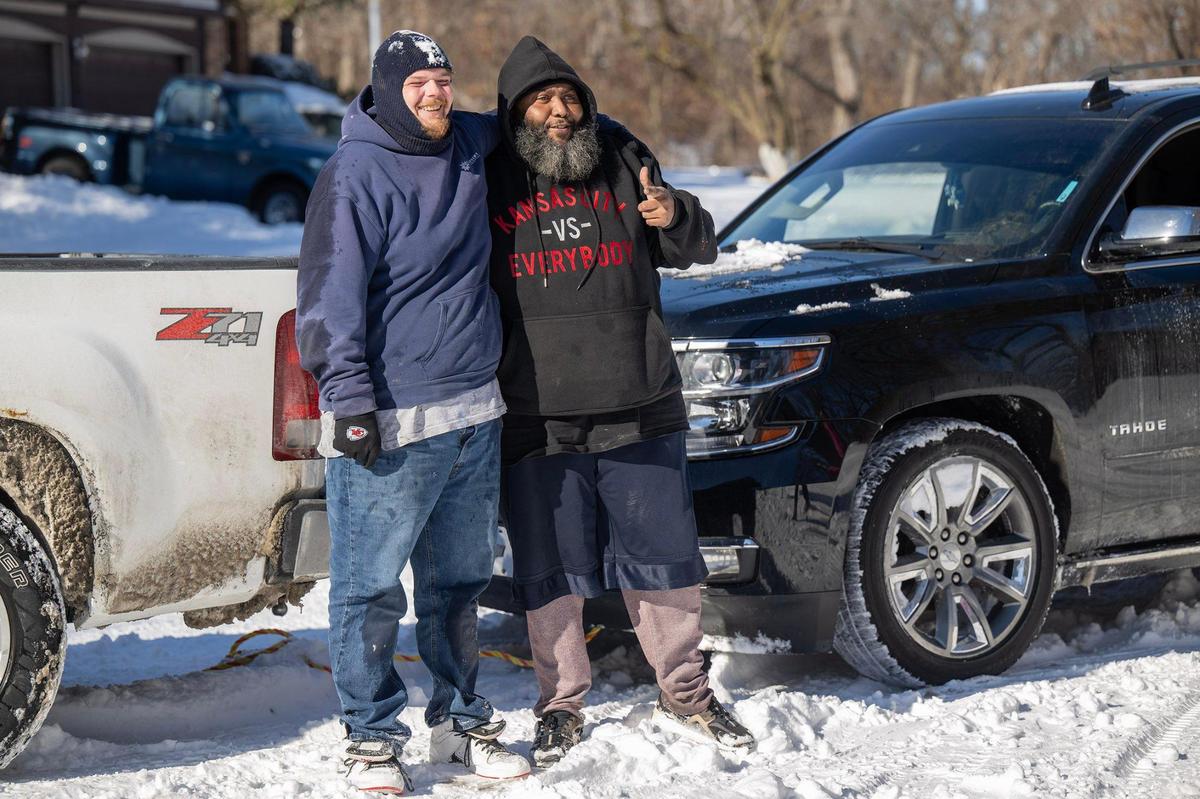 Corey Sutton, left, of Kansas City, Kansas, and Kendall Amos pose for a photo after Sutton helped pull Amos’ vehicle from a snowbank.