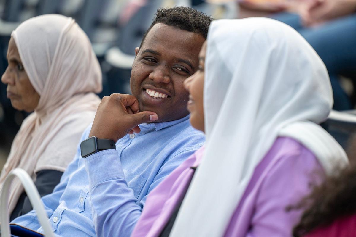 Ahmed Mohamedsalih, a native of Sunday, smiles at his wife, Waad Taha, before taking the Oath of Allegiance Thursday.