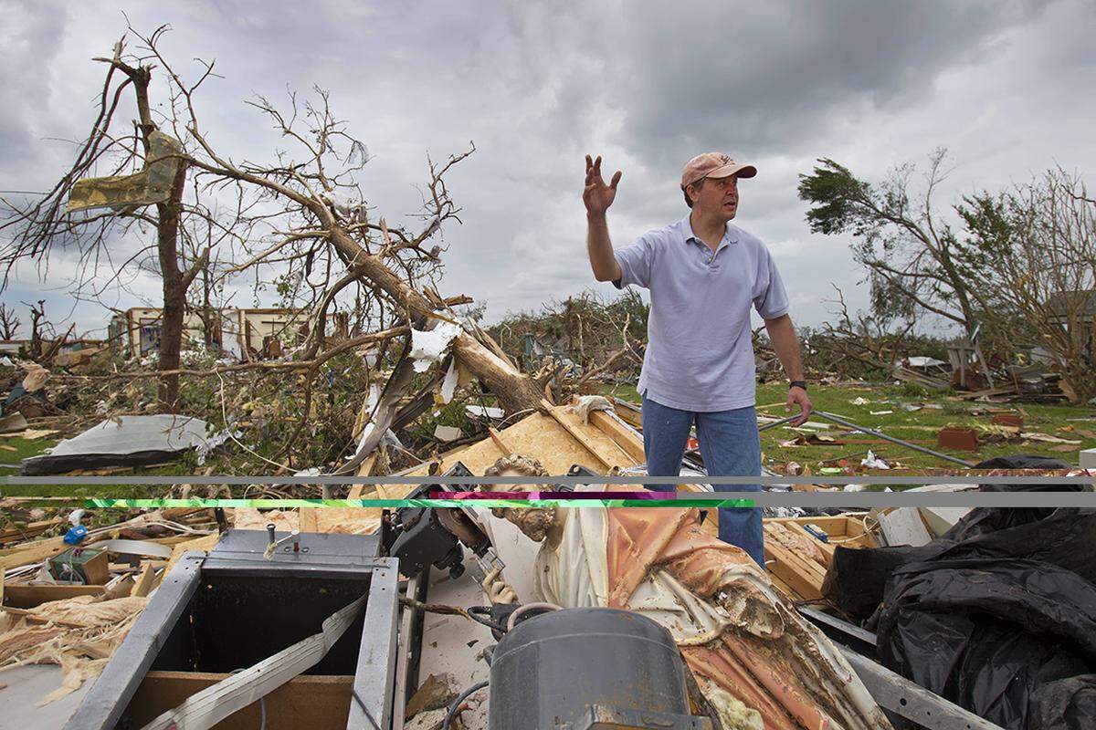Thane Snider worked in the yard of his childhood home after the storm. A statue of St. Peter lay among the rubble as Snider looked for power tools to assist in the cleanup. 