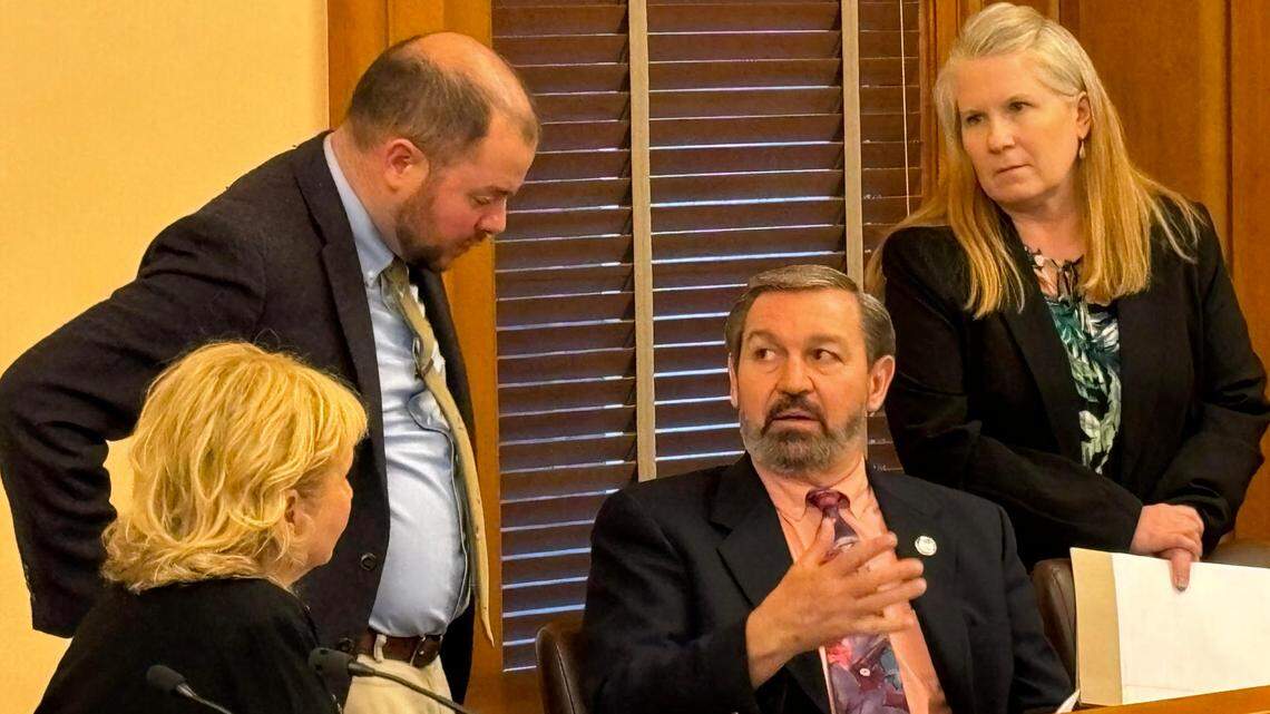 Sen. Virgil Peck, center, speaks with Sen. Caryn Tyson, left, and legislative staffers on Friday night.