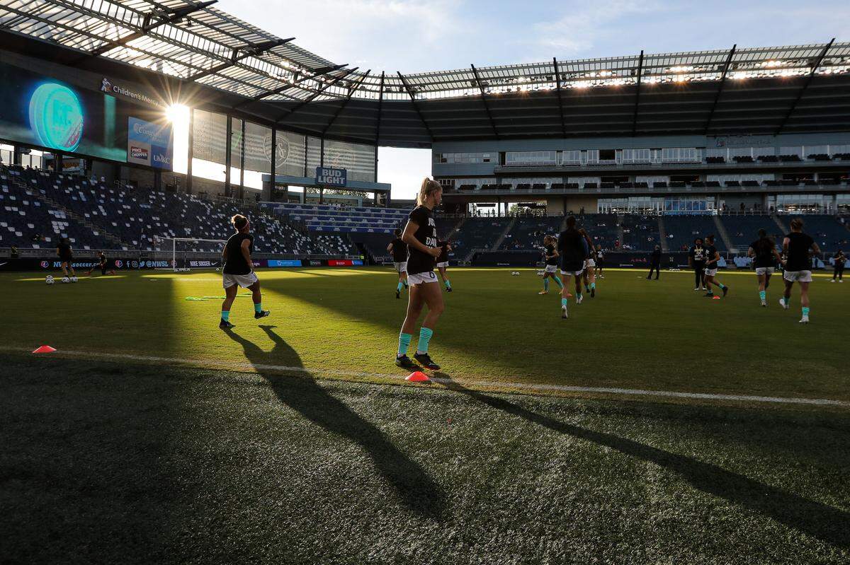Members of the KC NWSL team warm up before the season’s home-opening match against the Houston Dash at Children’s Mercy Park in Kansas City, Kan. April 26, 2021.