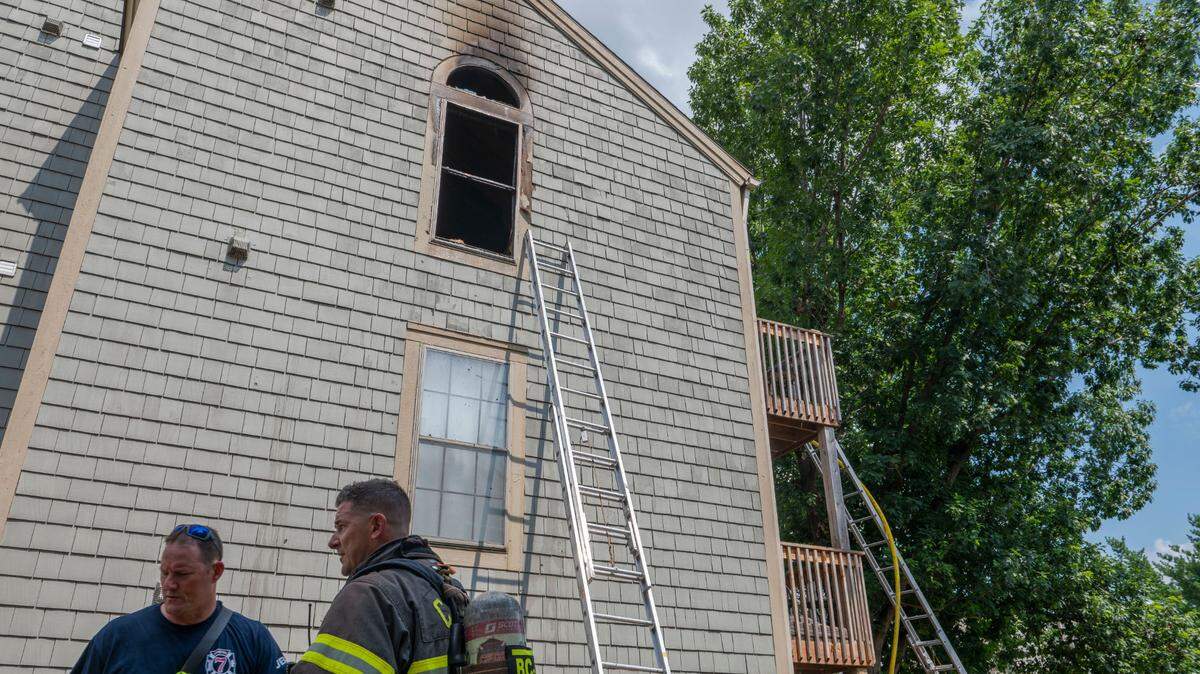 Fire crew members report to a fire at an apartment building in Shawnee on Sunday, July 3, 2022.
