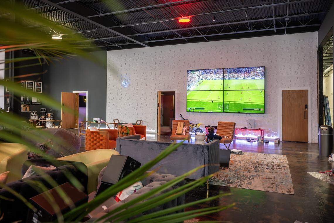 A lounge area with seating and large TV screens is seen in the DISTRKCT space at Agnes Arts on Tuesday, Nov. 25, 2025, in Kansas City.