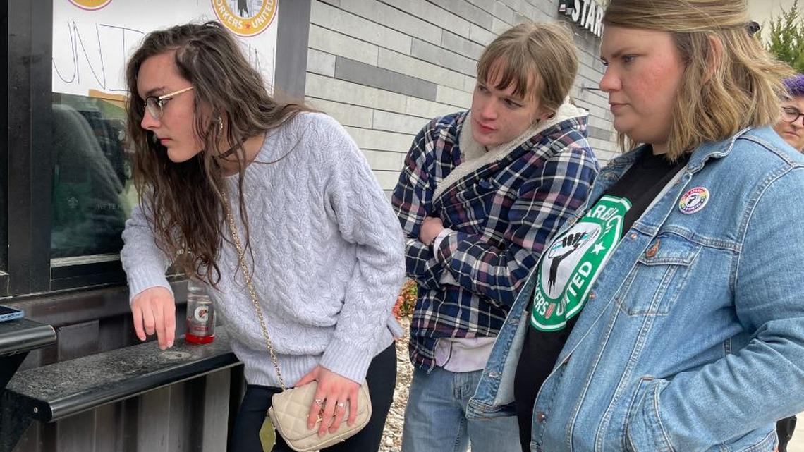 Starbucks workers Emma Baldridge (left), Calvin Culey and Hannah Edwards watch and wait while ballots are counted in a union election Friday at the coffee chain’s location at 10201 West 75th Street in Overland Park. The action at the store was part of a wave of organizing drives at Starbucks stores across the country.