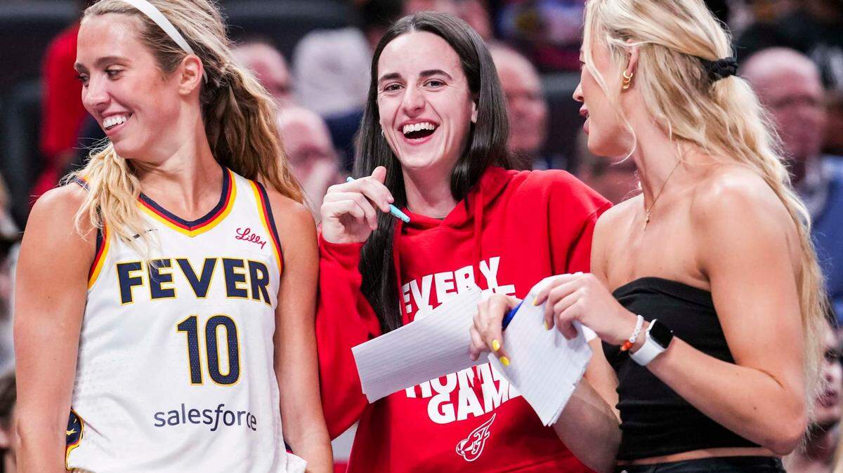 Indiana Fever guards Lexie Hull (from left), Caitlin Clark and Sophie Cunningham laugh near the team bench Tuesday, June 3, 2025, during a game against the Washington Mystics at Gainbridge Fieldhouse in Indianapolis.