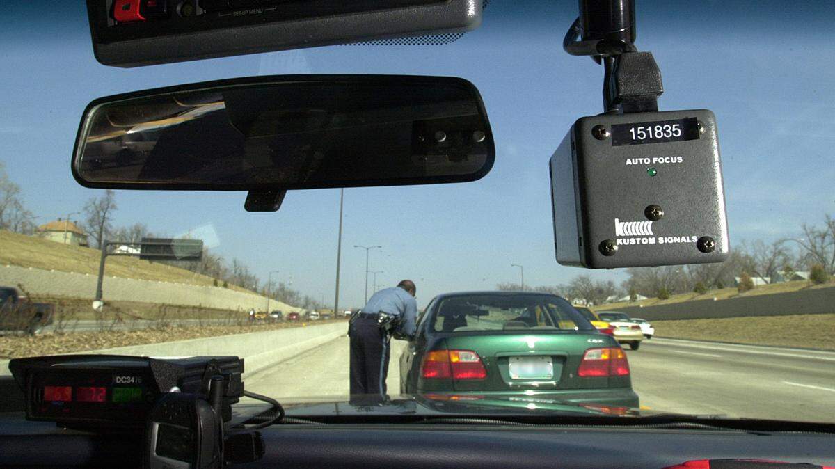 A Kansas City traffic enforcement officer makes a stop for a speeding violation. In Mississippi, it is legal to record police activity.