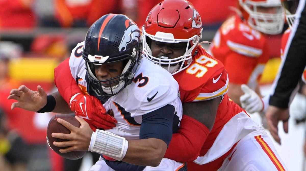 Denver Broncos quarterback Russell Wilson (3) was in the grasps of Kansas City Chiefs defensive tackle Khalen Saunders (99) during the second-half against the Denver Broncos on Sunday, Jan. 1, 2023, at GEHA Field at Arrowhead Stadium in Kansas City.