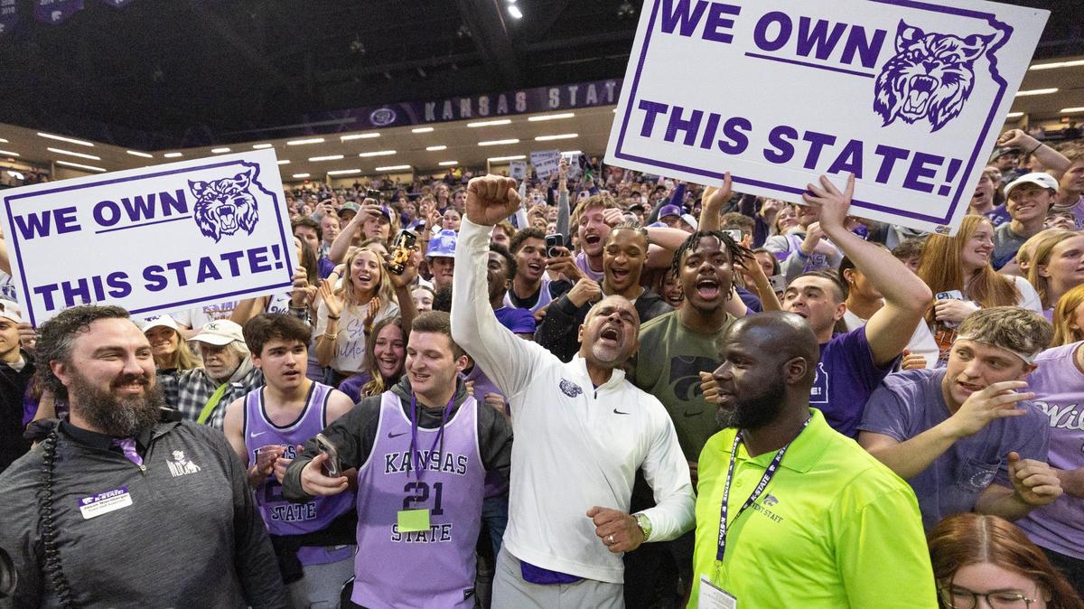 Kansas State coach Jerome Tang celebrates with fans after his team beat KU 75-70 in overtime in Manhattan on Monday, Feb. 5, 2024.