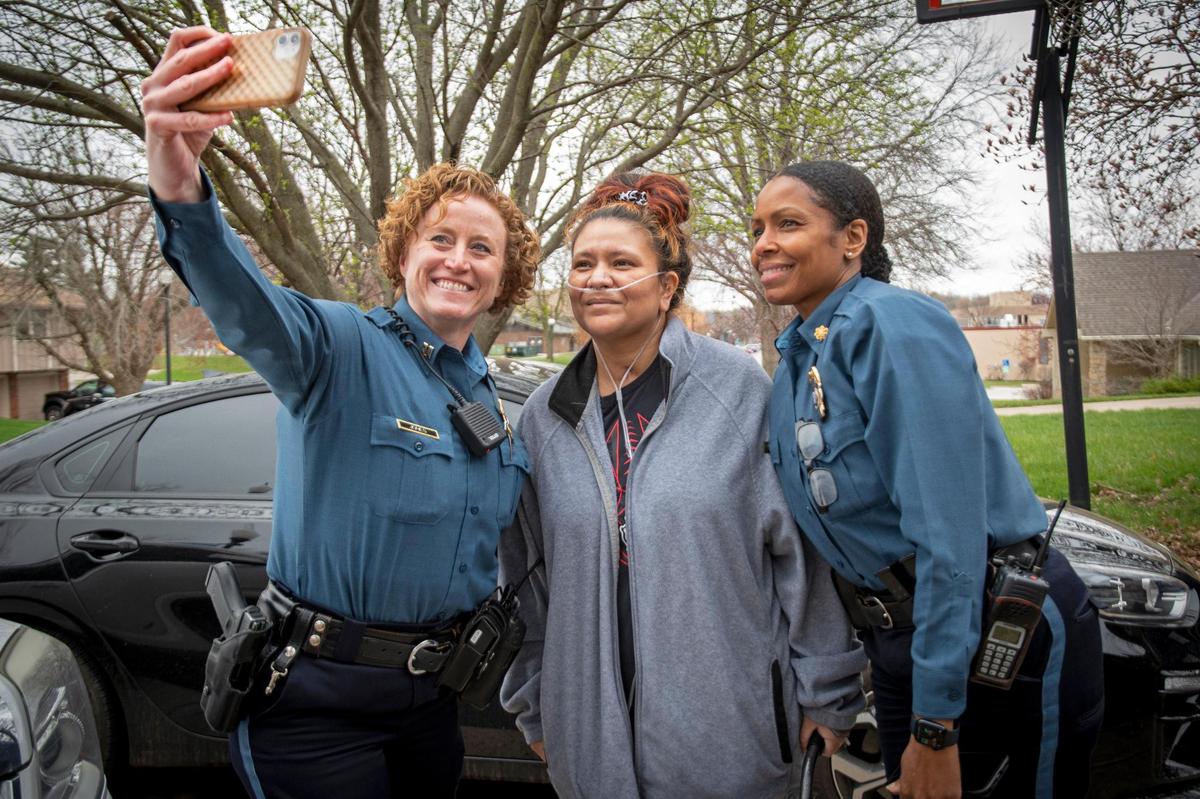 Major Kari Thompson, right, posed for a photo with fellow officers Lisa Sidenstick, center, and Capt. Jennifer Jones after Sidenstick returned to her Northland home. Sidenstick, a mother of four, had been battling COVID-19 since January.