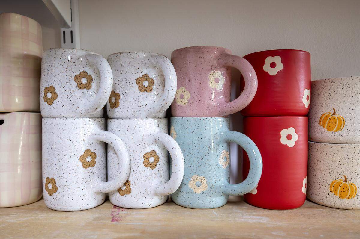Ceramic mugs made by ceramicist Priscilla Butler sit on shelves at her studio, Lila's Clayground, Thursday, Jan. 29, 2026, in Kansas City.