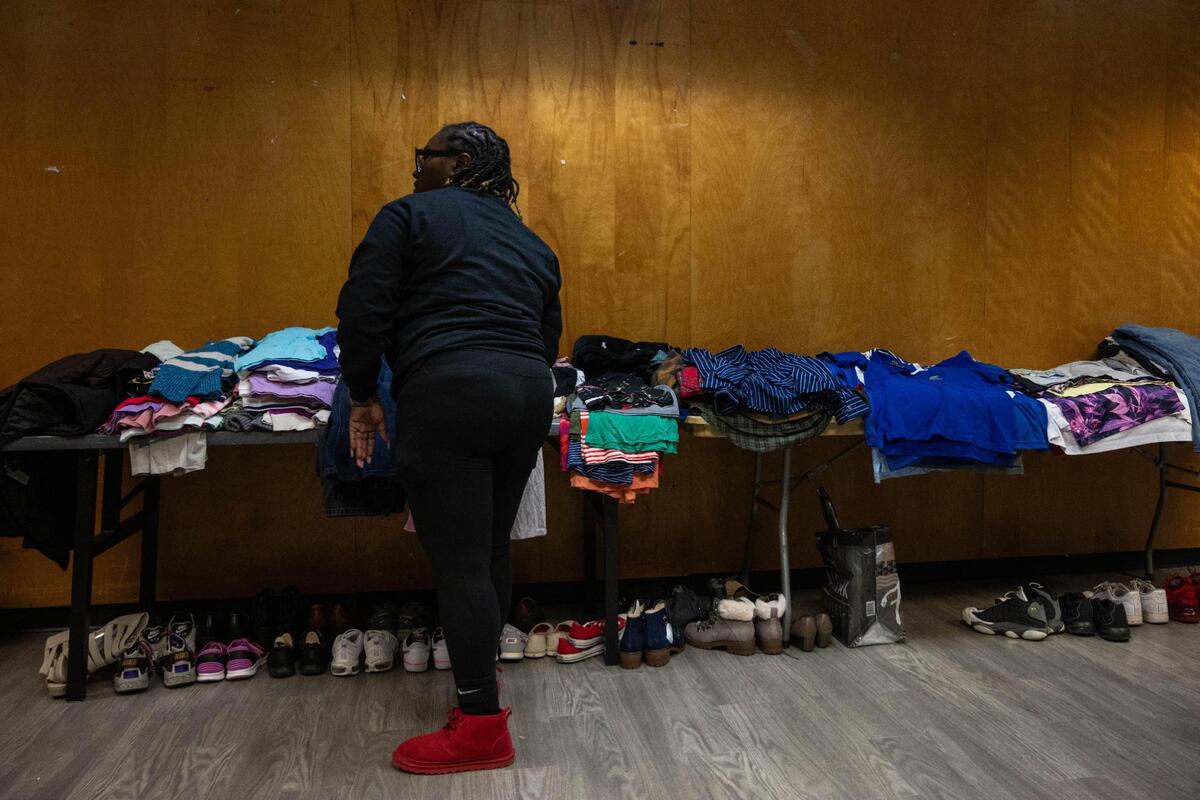 Volunteer Tiara Webb sorts through clothing being donated to families in need at the Gregg Klice Community Center in Kansas City on Giving Tuesday.