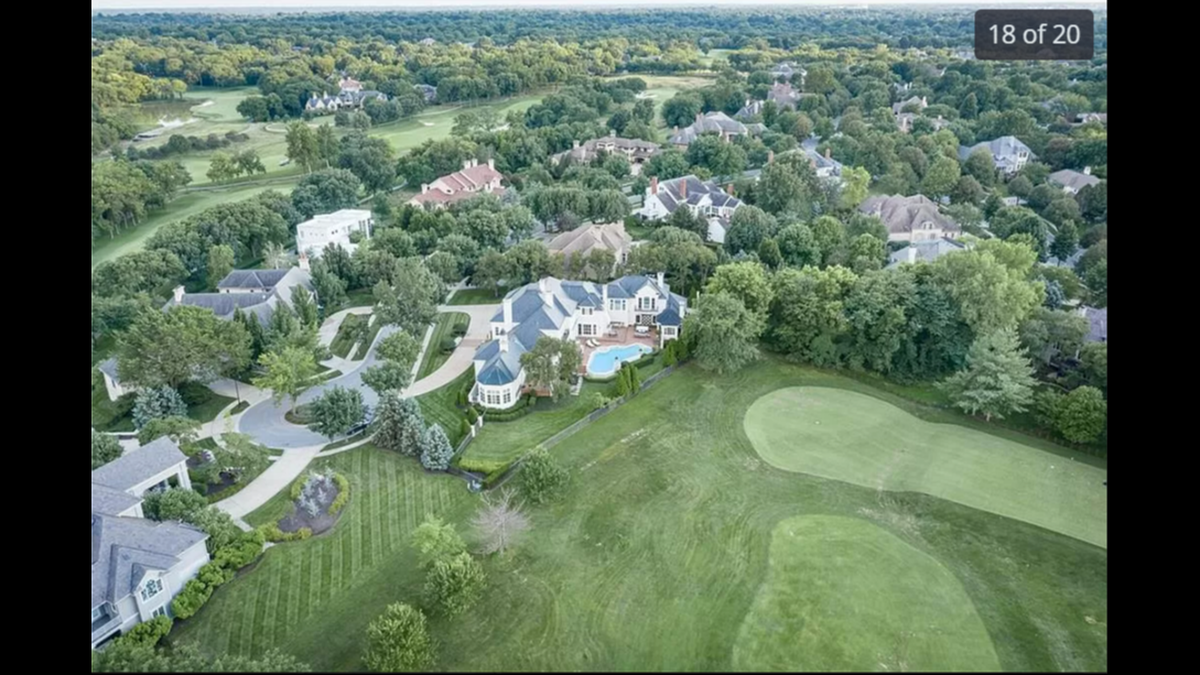 The backyard of the home at 2404 W. 114th St. includes a pool and a view of the Hallbrook Country Club’s private golf course.