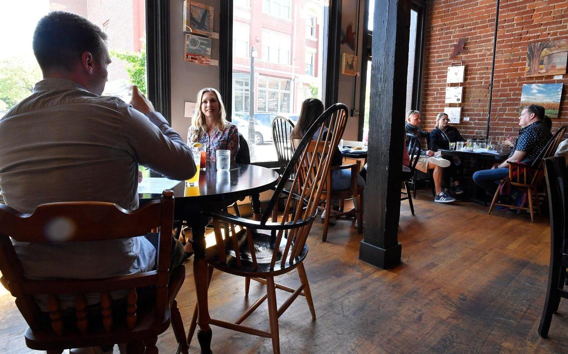 Happy about not being required to wear masks, Tucker Andis, left, and his mother, Liberty McLean, ate lunch Friday at The Farmhouse in the River Market. Kansas City Mayor Quinton Lucas announced Friday the city was fully lifting its emergency order.