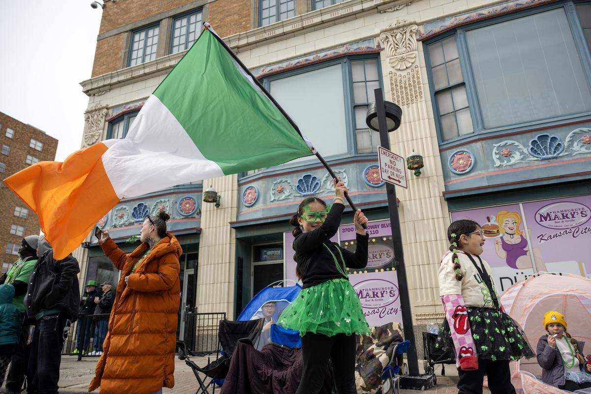 Arya Kim waves an Irish flag while attending the St. Patrick's Day parade on Tuesday, March 17, 2026, in Kansas City.