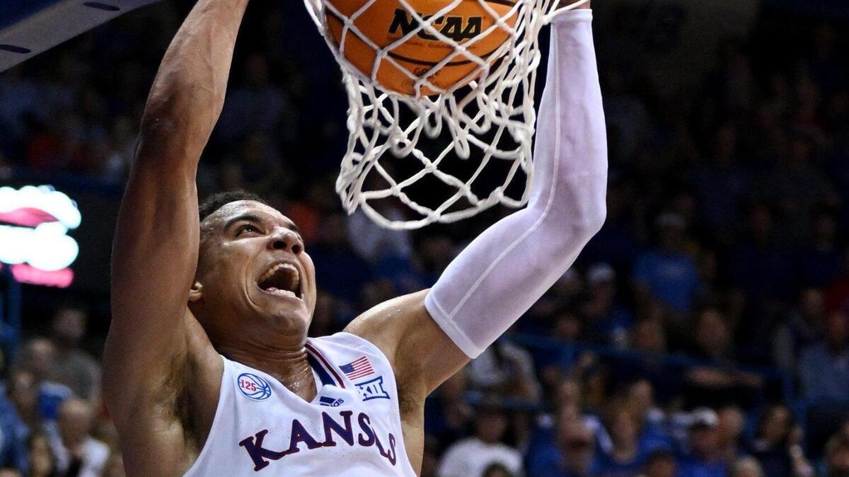 KU’s Kevin McCullar throws down a dunk after picking off a steal during the first half of Thursday night’s exhibition game at Allen Fieldhouse.