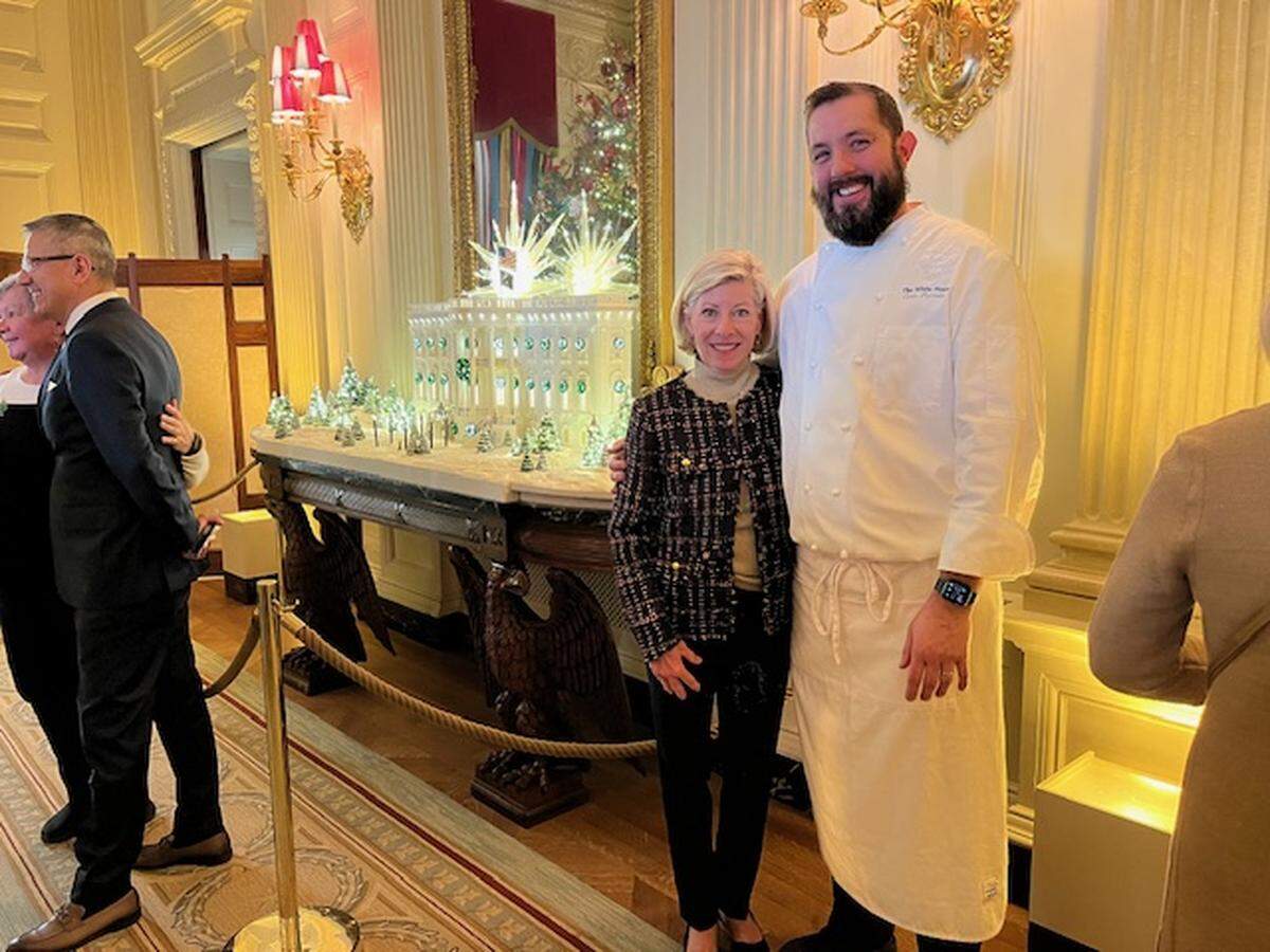 Wendy Clay with a White House pastry chef and this year’s Gingerbread White House.