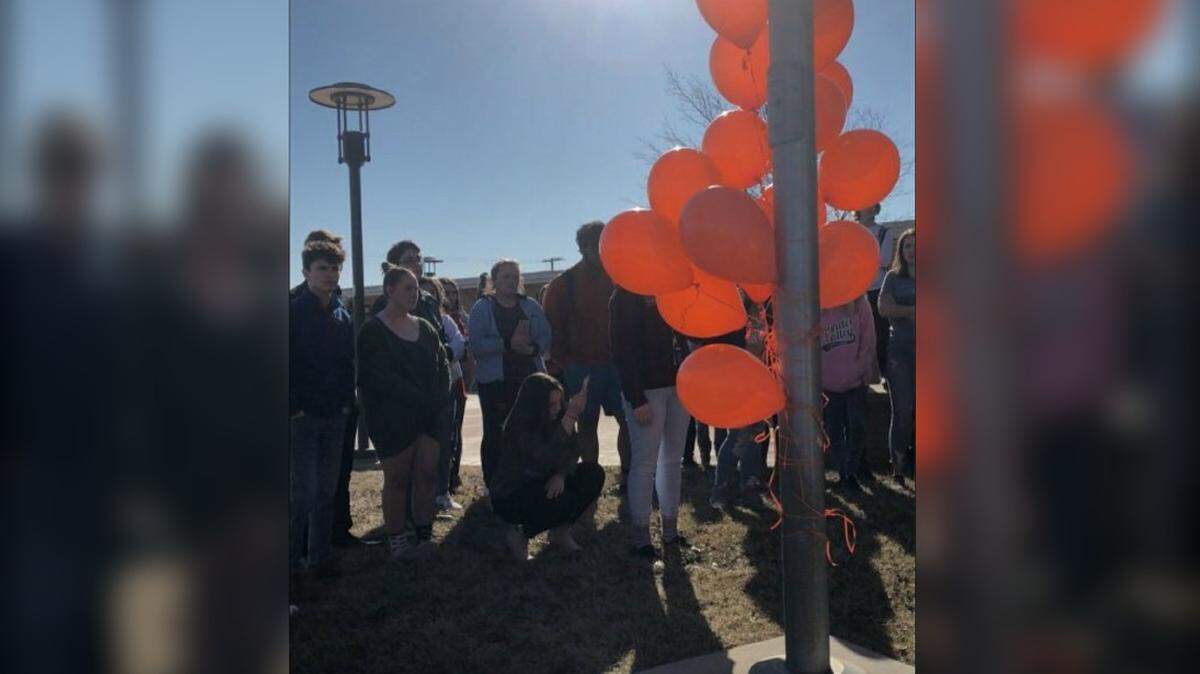 Park Hill High School students tied 17 balloons to the school flag pole to commemorate the 17 victims of the Parkland school shooting during Wednesday's national walkout.