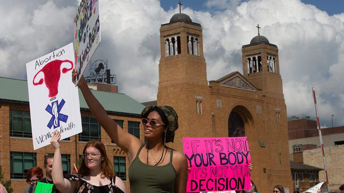 Abortion rights supporters took their messages with them as over a hundred marched around the Kansas Statehouse following a rally Saturday afternoon. reproductive rights value them both