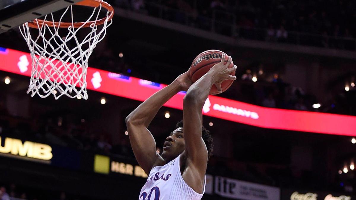 Kansas’ Ochai Agbaji flies by UTEP’s Keonte Kennedy for a dunk during the first half of the Jayhawks’ victory on Tuesday night at the T-Mobile Center in Kansas City.