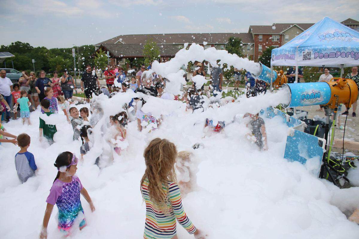 Around 100 people turned up to play in the sudes at a foam party at Indian Creek Library in Olathe in mid July.