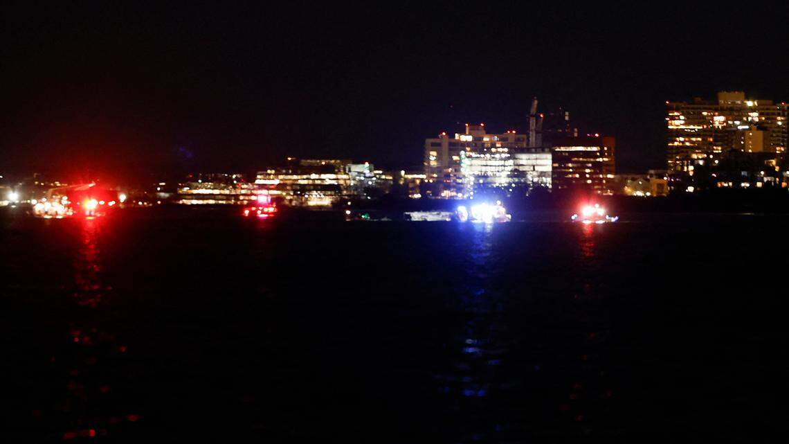 Lights from emergency vehicles and fireboats are seen as search and rescue operations are underway near Reagan National Airport as seen from Washington, D.C., after an air crash near the Potomac River on Wednesday, Jan. 29, 2025.