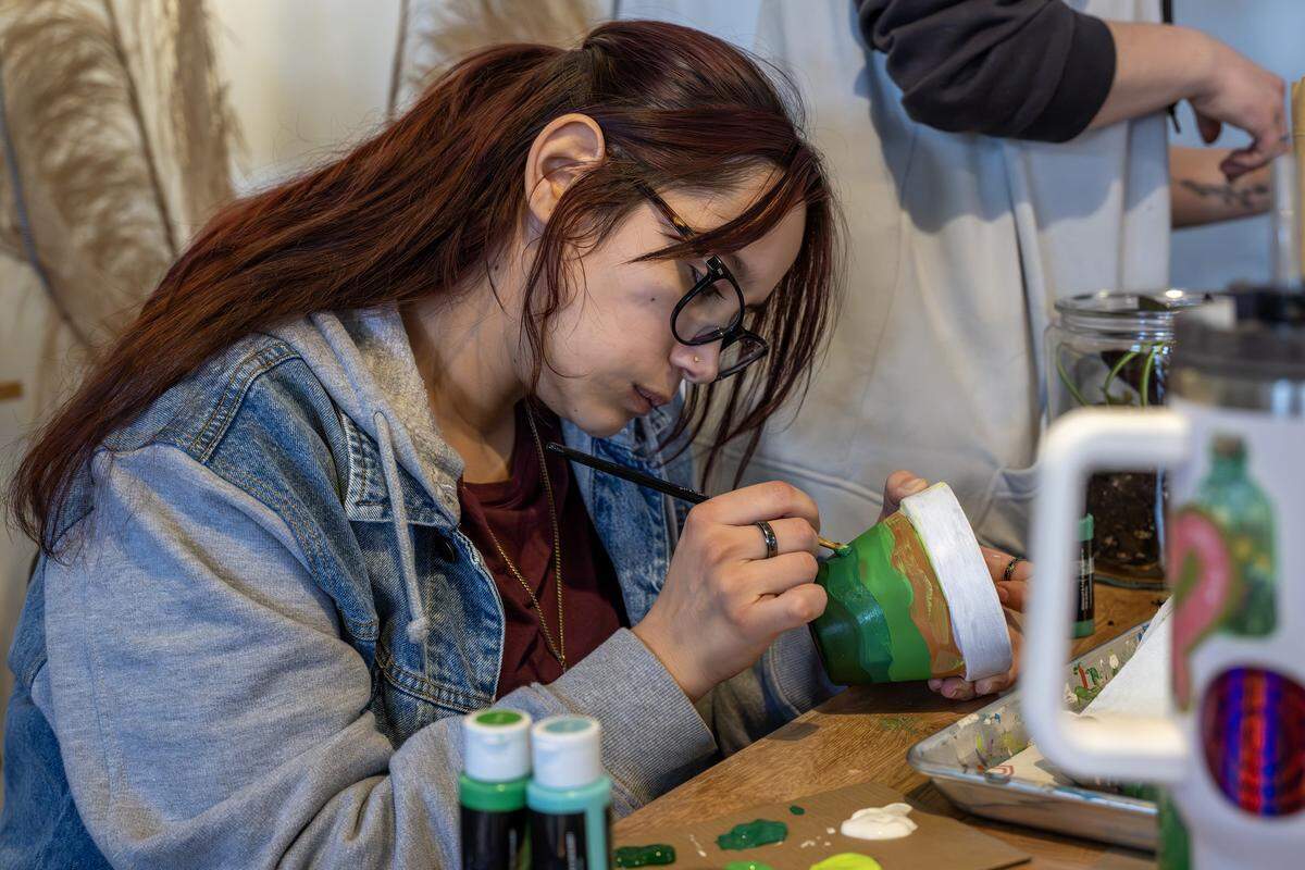 Maribel Gonzalez paints a plant ceramic pot at ADHDIY Craft Cafe on Saturday, Feb. 7, 2026, in Kansas City.