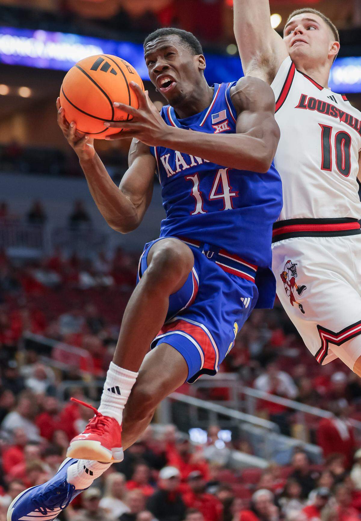 LOUISVILLE, KENTUCKY - OCTOBER 24: Melvin Council Jr. #14 of the Kansas Jayhawks shoots the ball against Isaac McKneely #10 of the Louisville Cardinals during the second half of the NCAA exhibition game between the Louisville Cardinals and Kansas Jayhawks at KFC YUM! Center on October 24, 2025 in Louisville, Kentucky. (Photo by Michael Hickey/Getty Images)