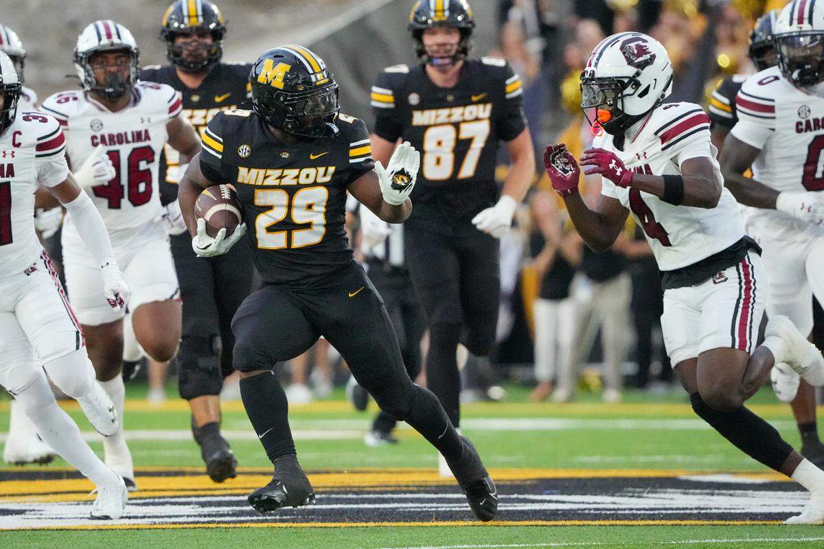 Missouri Tigers running back Ahmad Hardy (29) runs the ball as South Carolina Gamecocks defensive back Vicari Swain (4) defends during the first half of the game at Faurot Field at Memorial Stadium on Sept. 20, 2025.