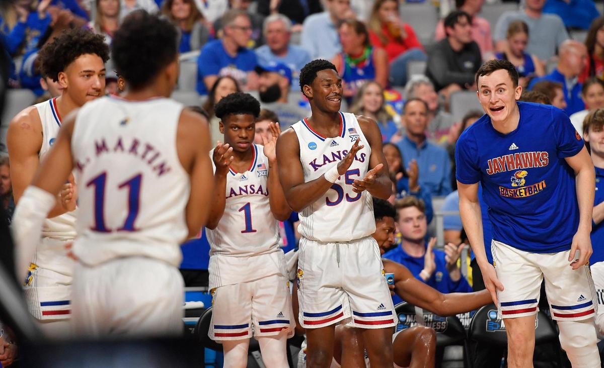 KU’s Remy Martin (11) gets a hand from his teammates after making a play during the second half of Thursday night’s first round NCAA Tournament game in Fort Worth. KU beat Southern, 83-56.