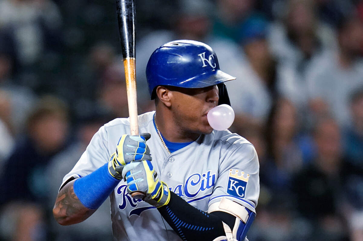 Kansas City Royals’ Salvador Perez blows a bubble as he stands in the batter’s box during the eighth inning against the Seattle Mariners in a baseball game Friday, Aug. 27, 2021, in Seattle. Perez flied out on at-bat. (AP Photo/Elaine Thompson)