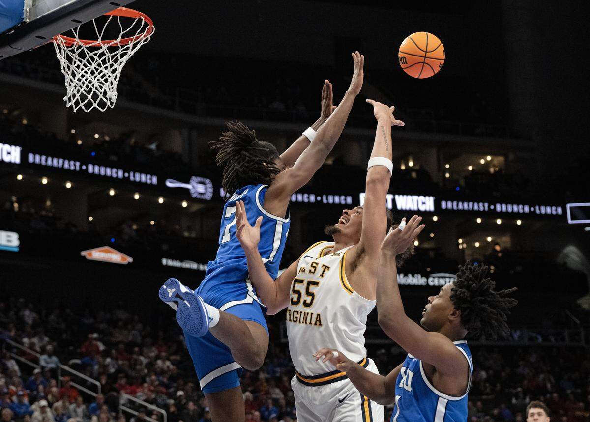 BYU Cougars forward Khadim Mboup (7) defends as West Virginia Mountaineers center Harlan Obioha (55) shoots during the second half of the Big 12 Men's Basketball Tournament at T-Mobile Center on Wednesday, March 11, 2026, in Kansas City.