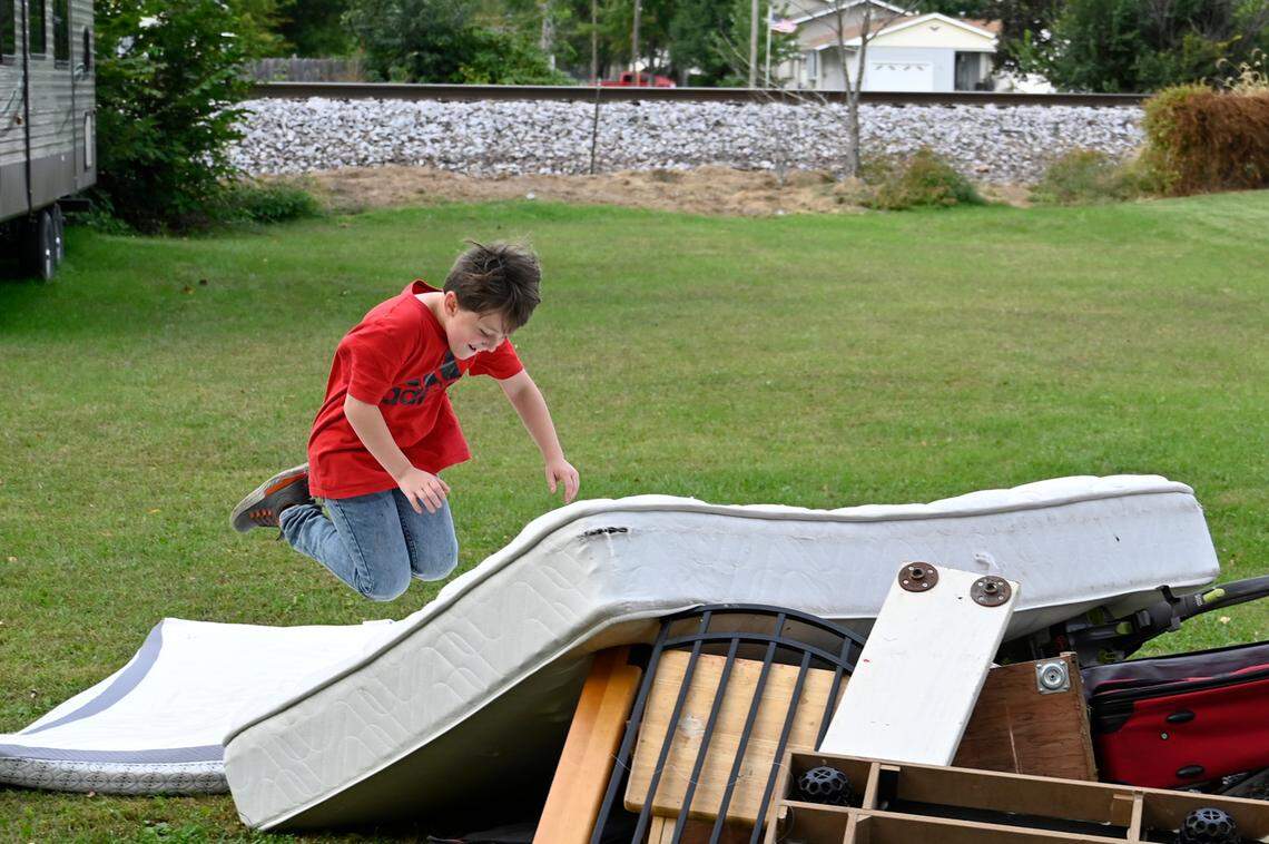 Drew Determann, 9, launched himself on a mattress set out for a bulky item pickup outside of his home in Camanache, Iowa. The Determann home, where kids often play outside, is about 100 feet from the railroad tracks.