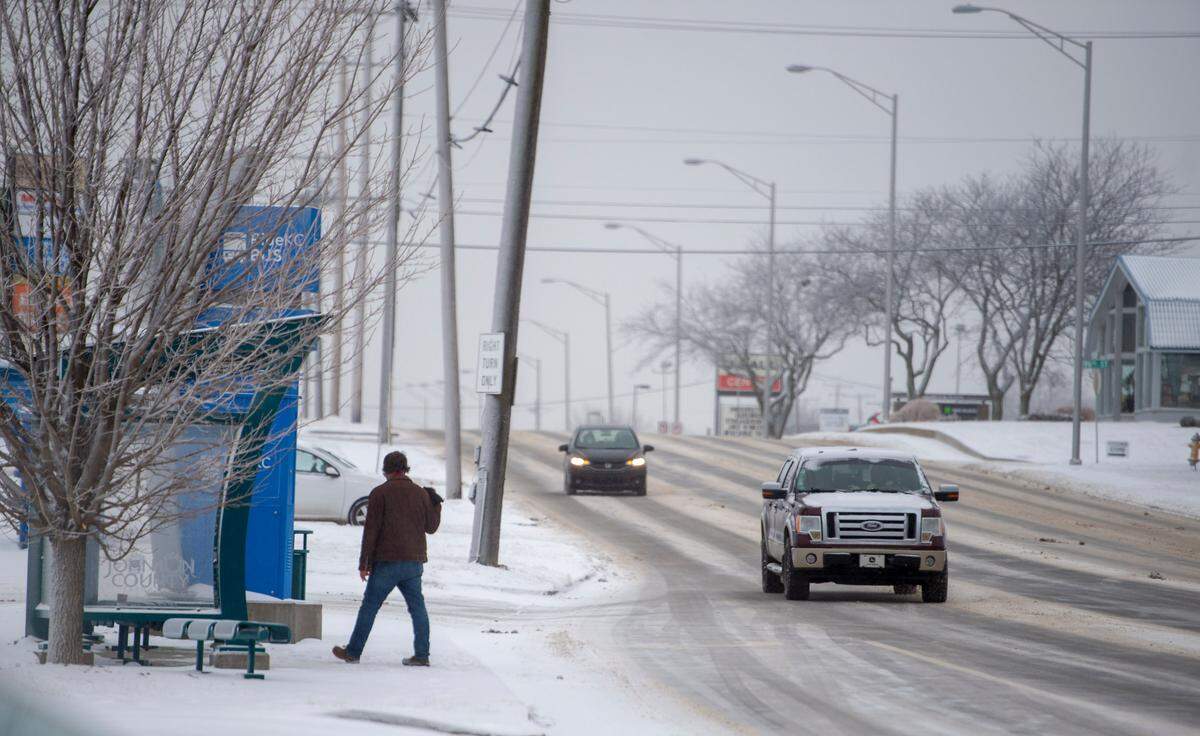 Motorists slowly navigated slick road conditions along Metcalf Avenue in Overland Park. A snowy, cold, arctic air settled in over the Kansas City area leaving the area with extremely cold temperatures for the next week.