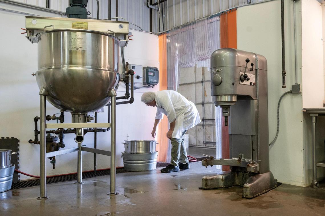 Dave Swiercinsky pulls the thermometer after checking the temperature on a corn syrup mixture for a batch of marshmallow cream.