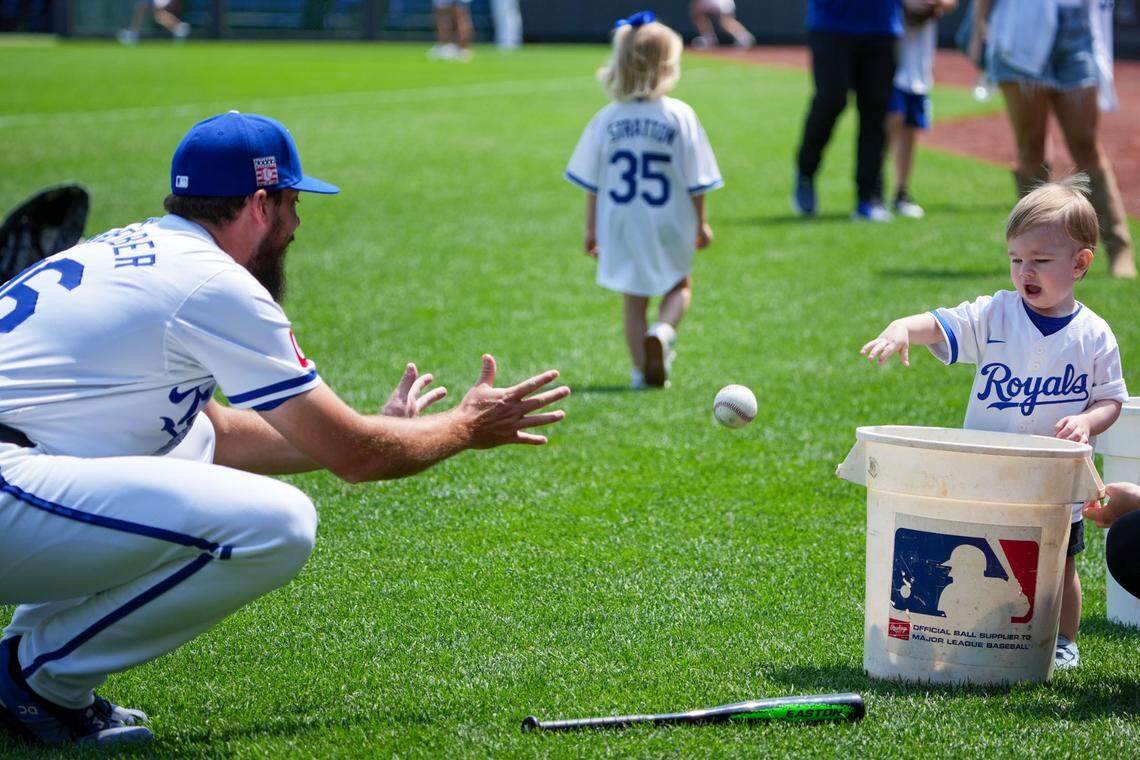 Kansas City Royals relief pitcher John Schreiber plays catch with his son Charlie during a Family Day event before Sunday afternoon’s game against the Chicago White Sox at Kauffman Stadium.