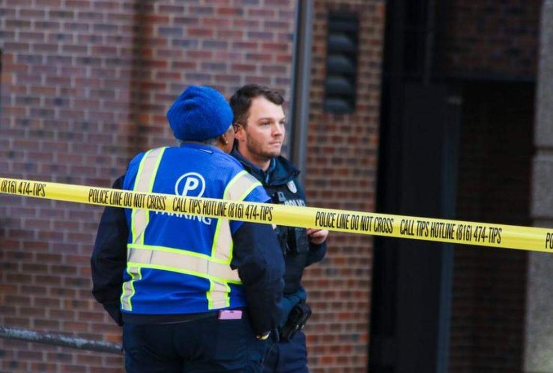 Police and employees stood outside University Health hospital in Kansas City after a shooting injured a security guard. 