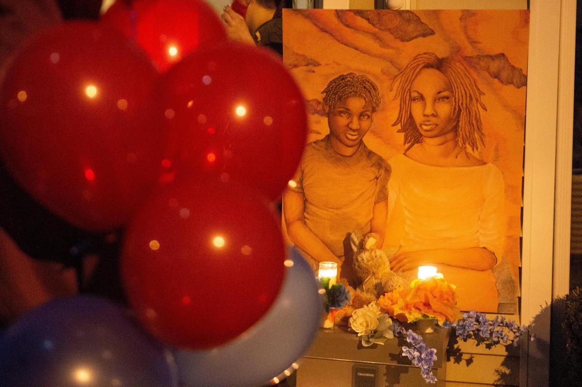 A drawing of homicide victims Khasheme Strother, 35, and her son Raymon Hill, 19, was placed outside their home in the 1900 block of Pennway Terrace during a balloon release vigil Monday night, Feb. 22, 2021. The artwork was provided by Mattie Rhodes Art Center in Kansas City’s Westside neighborhood. Strother and her son were shot and killed Wednesday in Kansas City.