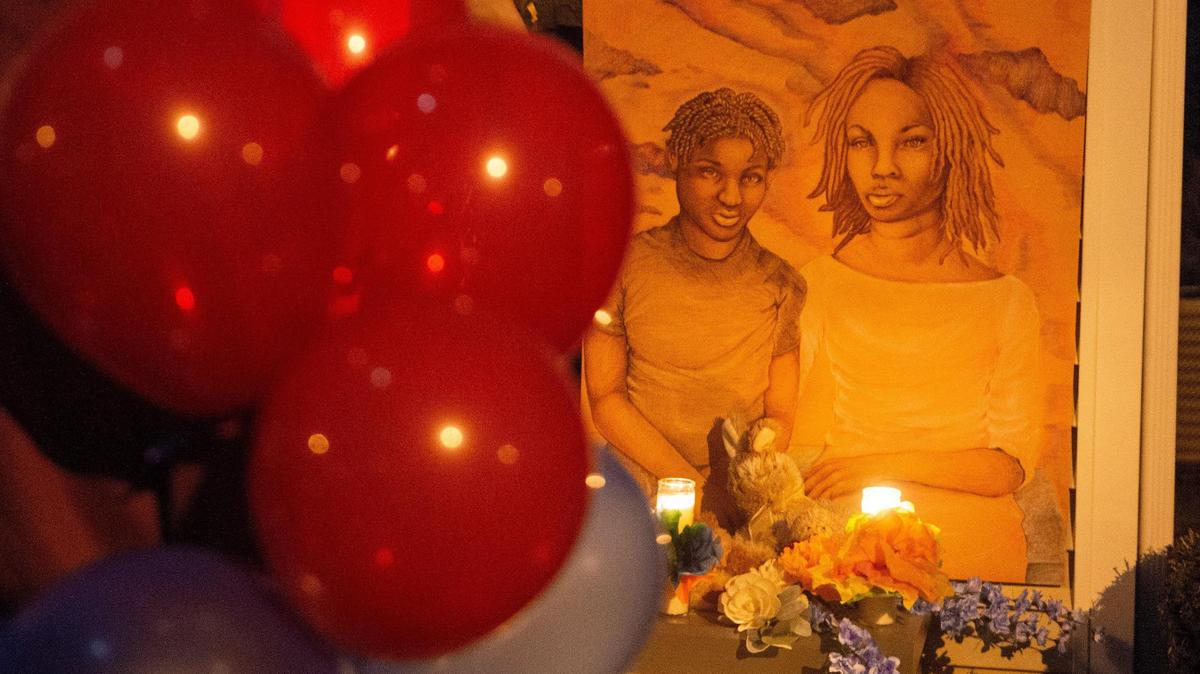 A drawing of homicide victims Khasheme Strother, 35, and her son Raymon Hill, 19, was placed outside their home in the 1900 block of Pennway Terrace during a balloon release vigil Monday night, Feb. 22, 2021. The artwork was provided by Mattie Rhodes Art Center in Kansas City’s Westside neighborhood. Strother and her son were shot and killed.
