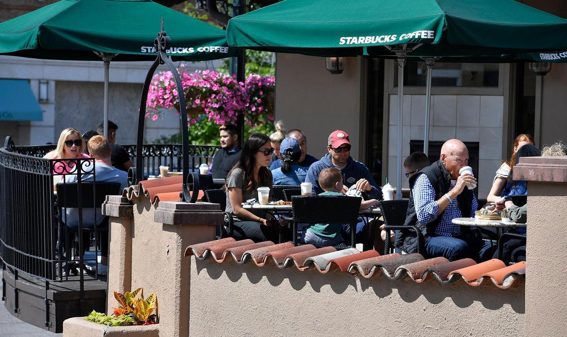 Customers at Starbucks on the Country Club Plaza could shed their masks as Mayor Quinton Lucas announced Friday the city is fully lifting its COVID-19 emergency order.