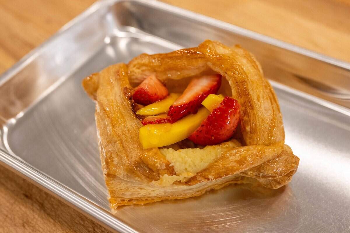 A puffed pastry filled with cream cheese, mango, and strawberry at the soft opening for Bodega Bakery, a new cafe from the owner's of Blackhole Bakery, on Friday, December 12, 2025, in Kansas City.