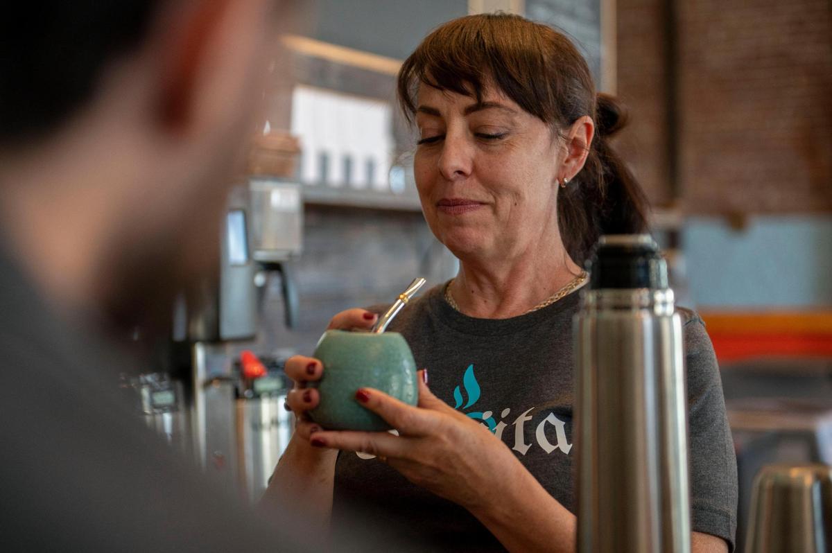 Miel Castagna-Herrera, a co-owner of Café Corazón, demonstrates how to make a Yerba-Mate to employees at Café Corazón in the Crossroads Arts District.