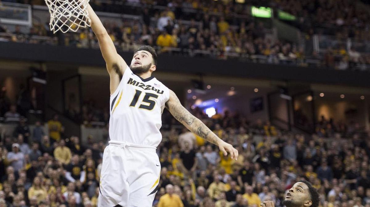 Missouri Tigers guard Jordan Geist (15) scored on a break away as Arkansas Razorbacks guard Daryl Macon (4) tried to catch-up in the first half during the University of Missouri and University of Arkansas Southeastern Conference basketball game at Mizzou Arena on Saturday, March 3, 2018, in Columbia, Missouri.