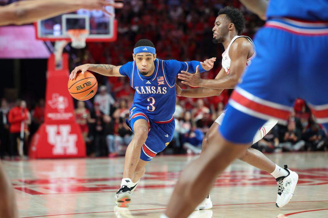 Kansas Jayhawks guard Dajuan Harris Jr. (No. 3) drives past Houston Cougars guard L.J. Cryer during a Big 12 college basketball game at the Fertitta Center in Houston on Monday, March 3, 2025.