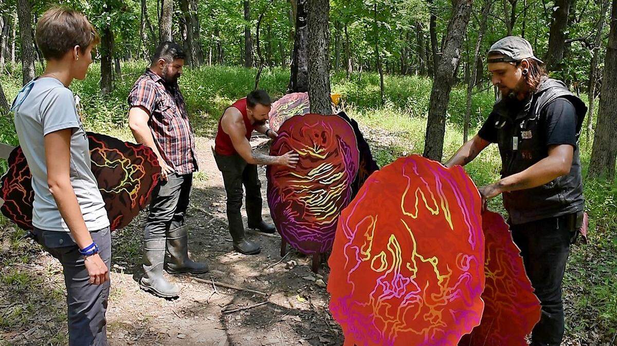 Local artist Shawn Bitters, middle, was joined recently by other artists who helped install Bitters’  3/4-mile participatory piece of art “Burn Out’’ along the Rancho D-Lux Trail in Swope Park. 