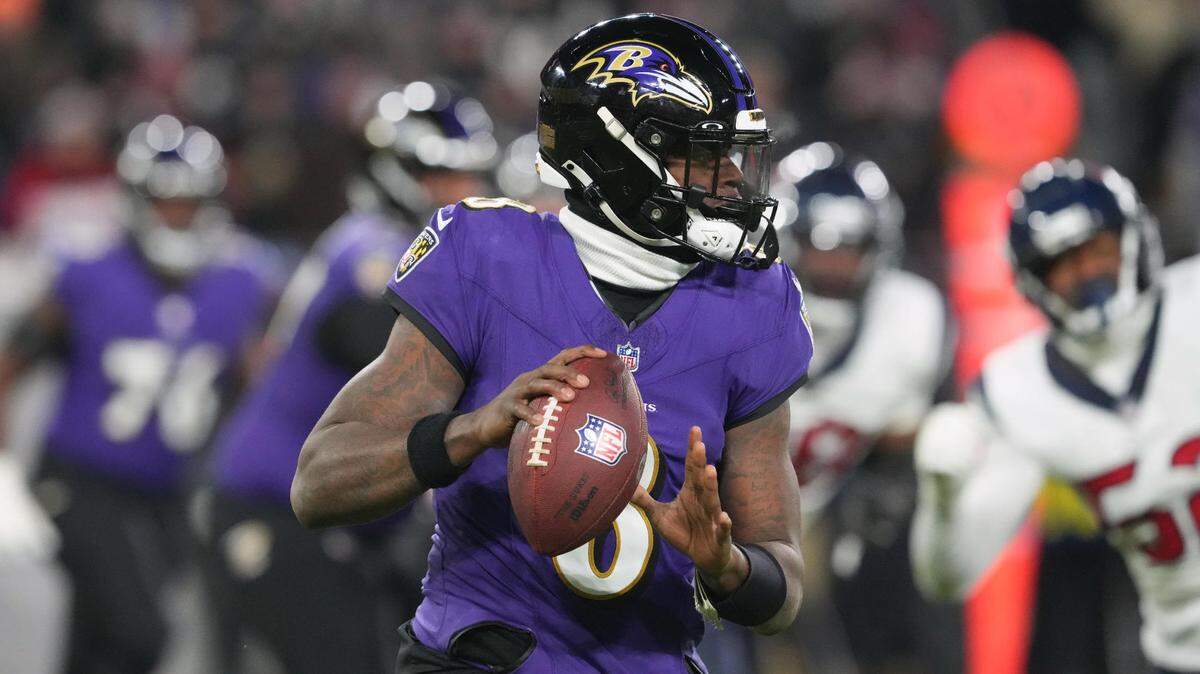 Baltimore Ravens quarterback Lamar Jackson (8) rolls out to throw against the Houston Texans during the second quarter of a 2024 AFC divisional round game at M&T Bank Stadium.