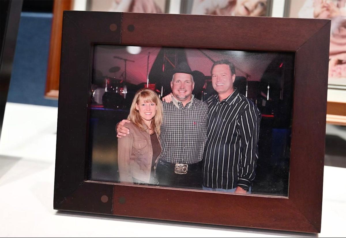 In his office, Bill Self displays a photo of him and his wife, Cindy, with longtime friend Garth Brooks. She went to high school with the country star. Self played softball with him in Oklahoma.