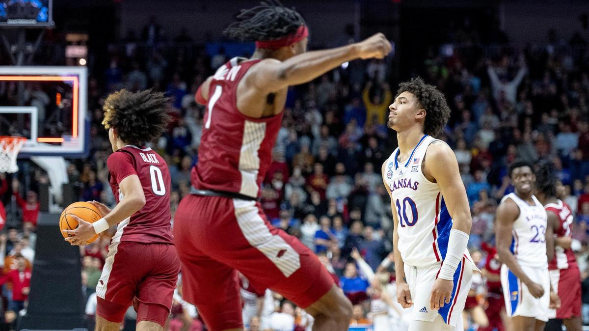 Kansas forward Jalen Wilson (10) walks off the court as Arkansas guard Anthony Black (0) and guard Ricky Council IV (1) celebrate their 72-71 win in a second-round college basketball game in the NCAA Tournament Saturday, March 18, 2023, in Des Moines, Iowa.