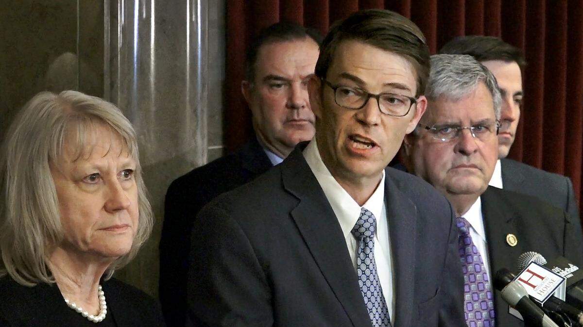 Missouri House Speaker Todd Richardson (center) and Senate President Ron Richard (second from right) on Tuesday called on Gov. Eric Greitens, a fellow Republican, to resign.