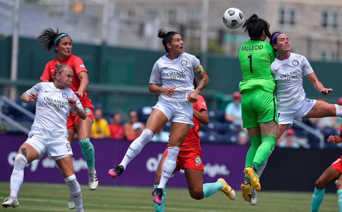 Orlando goalie Erin McLeod (1) ran into her teammates Ali Krieger, left, and Phoebe McClernon as Kansas City NWSL’s Talor Leach, left, tries to position herself for a header during the first period of Wednesday’s game at Legends Field.