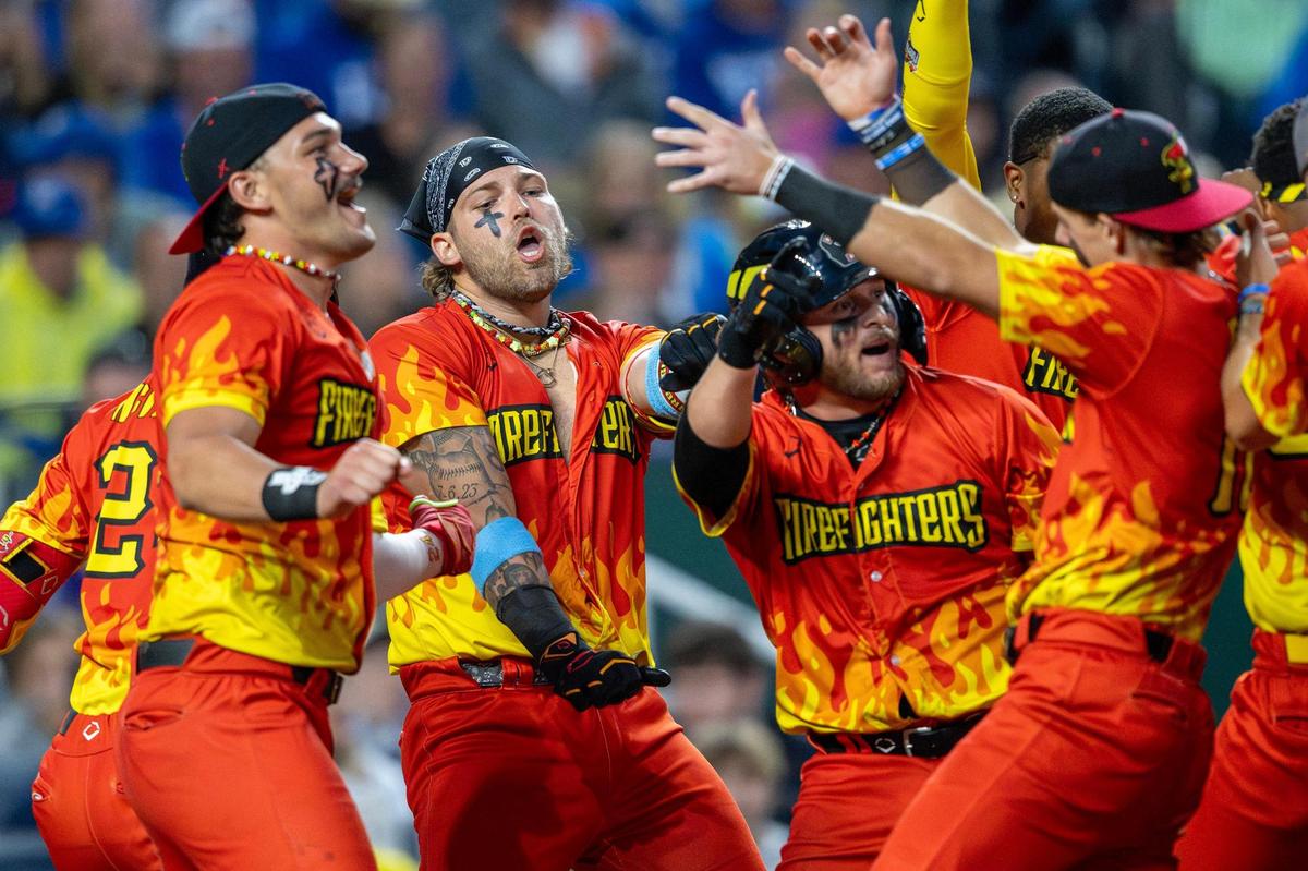 The Firefighters perform a dance routine in the eighth inning after tying the game during a Banana Ball game against the Savannah Bananas at Kauffman Stadium on Friday, May 23, 2025, in Kansas City.